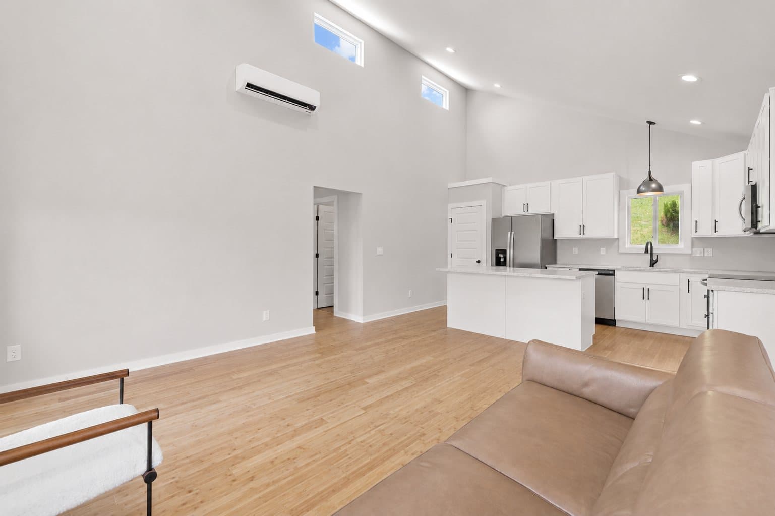 Single Level Cottage 2 Bed, open living room and kitchen with vaulted ceiling